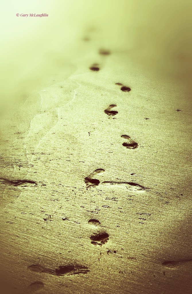 Footsteps in the sand on a Donegal beach